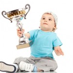 small boy holding a winners cup