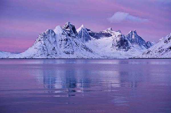 Scenic winter view across Kjerkfjorden towards Vindstad, near Reine, Lofoten islands, Norway